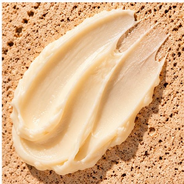 A swatch of whipped shea butter on travertine